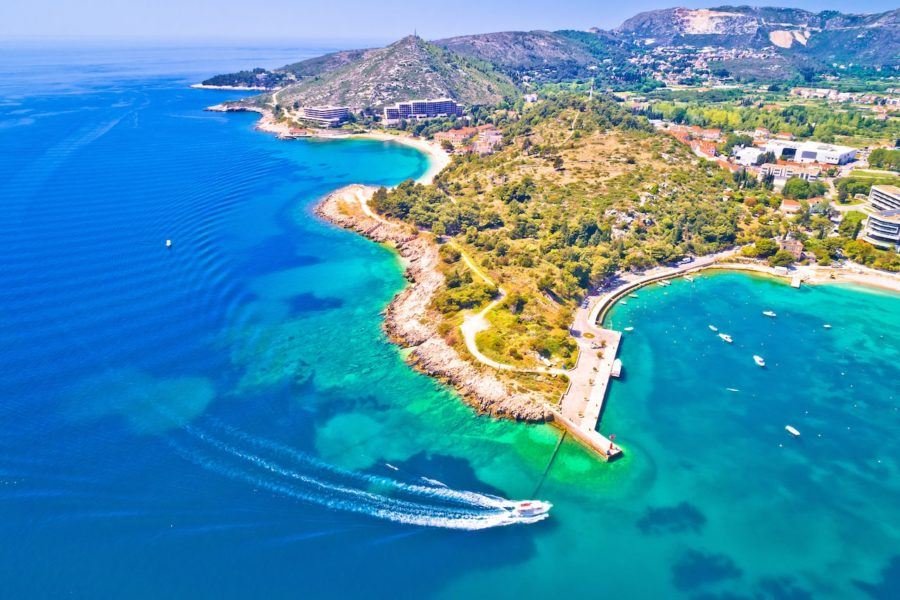 An aerial view of a bay with a boat in the water in Split, Croatia.